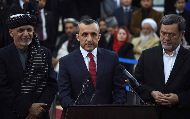 Afghan President Ashraf Ghani (L) and Sarwar Danish (R), his current second vice president look on as his first vice-presidential candidate Amrullah Saleh (C) speaks to the media at the Independent Electoral Commission office in Kabul on January 20, 2019. - President Ashraf Ghani on January 20 formally registered as a candidate for Afghanistan's delayed presidential election, setting up a rematch with Chief Executive Abdullah Abdullah in the July ballot. (Photo by WAKIL KOHSAR / AFP)