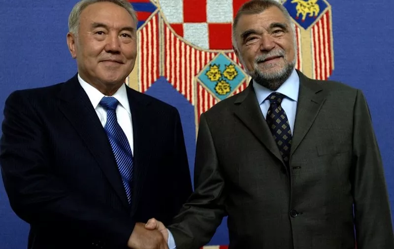 Kazakh President Nursultan Nazarbayev (L) and his Croatian counterpart Stipe Mesic shake hands before a meeting in Zagreb, 11 July 2006. Nazarbayev started an official two-day visit to Croatia.    AFP PHOTO/Denis Lovrovic (Photo by AFP)