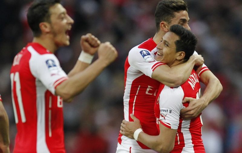 Arsenal&#8217;s Chilean striker Alexis Sanchez (R) celebrates with Arsenal&#8217;s Brazilian defender Gabriel after scoring his second goal during the FA Cup semi-final between Arsenal and Reading at Wembley stadium in London on April 18, 2015. AFP PHOTO / NOT FOR MARKETING OR ADVERTISING USE / RESTRICTED TO EDITORIAL USE