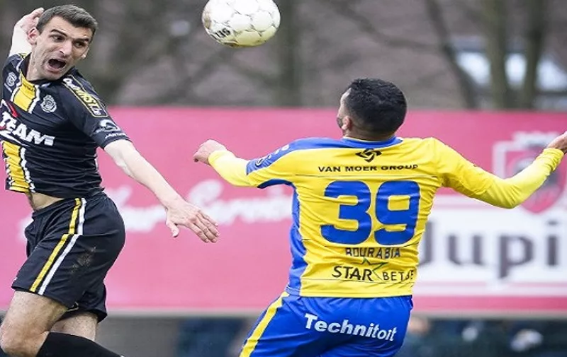 A picture taken on March 15, 2015 shows Lokeren's Gregory Mertens (L) vying with Waasland-Beveren's Rachid Bourabia during the Jupiler Pro League match between Waasland-Beveren and Lokeren in Beveren-Waas. Belgian footballer Gregory Mertens was in a critical state in hospital on April 28 after suffering a heart-attack playing for Lokeren reserves the previous night, press reports said.  AFP PHOTO / BELGA / LAURIE DIEFFEMBACQ   ***BELGIUM OUT***