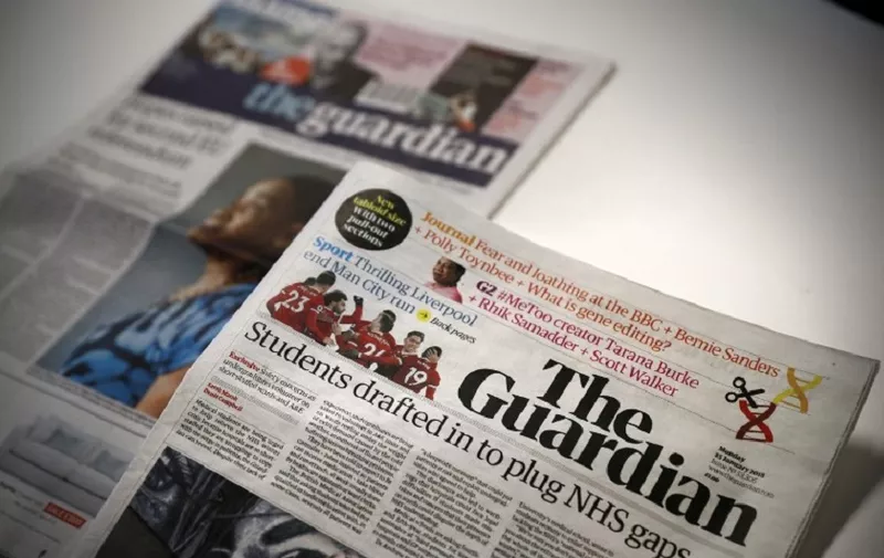The new look tabloid Guardian is on show next to the old broadsheet version of the national newspaper on January 15, 2018.
Britain's Guardian newspaper has adopted a new tabloid format and a re-designed masthead with simple black lettering from Monday as part of a drive to cut costs. The left-leaning newspaper previously had a blue and white masthead and in 2005 had adopted a Berliner format, midway between a broadsheet and a tabloid.
 / AFP PHOTO / ADRIAN DENNIS