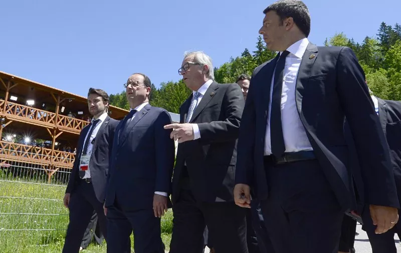 (From 2ndL to R) French President Francois Hollande, European Union Commission President Jean-Claude Juncker and Italy's Prime Minister Matteo Renzi are on their way to the first working session of a G7 summit at the Elmau Castle near Garmisch-Partenkirchen, southern Germany, on June 7, 2015. Germany hosts a G7 summit at the Elmau Castle on June 7 and June 8, 2015.  AFP PHOTO / JOHN MACDOUGALL