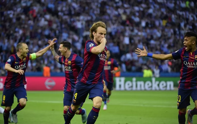 Barcelona's Croatian midfielder Ivan Rakitic (C) celebrates after scoring during the UEFA Champions League Final football match between Juventus and FC Barcelona at the Olympic Stadium in Berlin on June 6, 2015.     