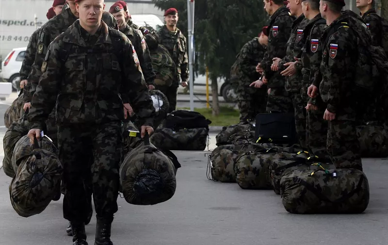 Soldiers of the 10th motorized battalion of Slovenian Army carry their bellongings before boarding a plane, 16 February 2007 in Ljubljana, as they leave to the troubled UN administrated Serbian province of Kosovo to join NATO-led KFOR security forces. The outgoing Serbian government called on the newly elected parliament to reject parts of the UN envoy's Martti Ahtisaari proposal for the future status of Kosovo on the grounds that it violates Serbia's territorial integrity. Ahtisaari unveiled his long-awaited plan for the future of Kosovo earlier this month, raising hopes of independence among the province's majority ethnic-Albanian population but drawing condemnation from Serbia.     AFP PHOTO/- (Photo by STRINGER / AFP)
