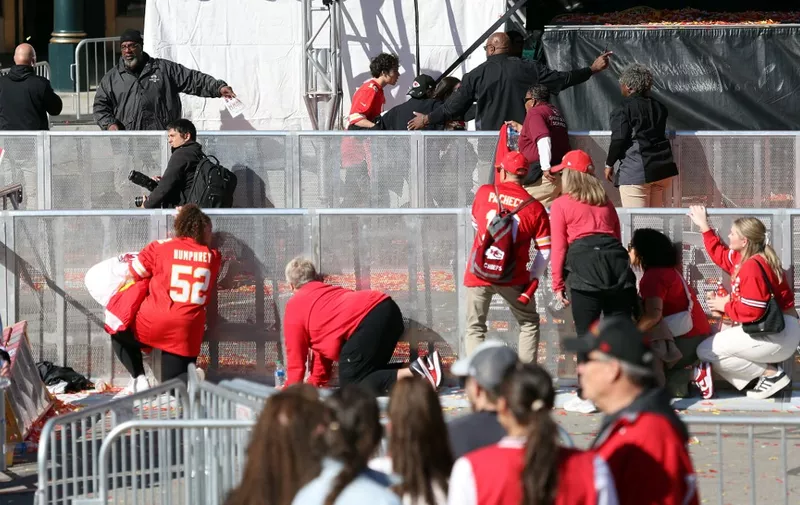 KANSAS CITY, MISSOURI - FEBRUARY 14: People take cover during a shooting at Union Station during the Kansas City Chiefs Super Bowl LVIII victory parade on February 14, 2024 in Kansas City, Missouri. Several people were shot and two people were detained after a rally celebrating the Chiefs Super Bowl victory.   Jamie Squire/Getty Images/AFP (Photo by JAMIE SQUIRE / GETTY IMAGES NORTH AMERICA / Getty Images via AFP)