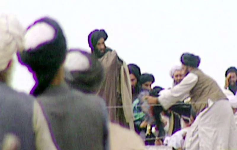 TV grabs taken secretly by BBC Newsnight shows Taliban's one-eyed spiritual leader Mullah Mohammed Omar (C) during a rally of his troops in Kandahar before their victorious assault on Kabul in 1996. AFP PHOTOMANDATORY CREDIT BBC NEWS/NEWSNIGHT