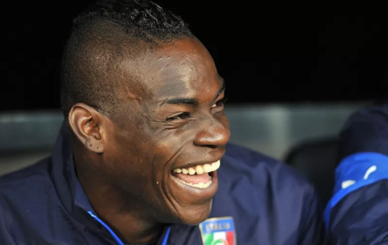 Italy's striker Mario Balotelli laughs before the international friendly football match between Italy and the Republic of Ireland at Craven Cottage in London on May 31, 2014. AFP PHOTO/GLYN KIRK