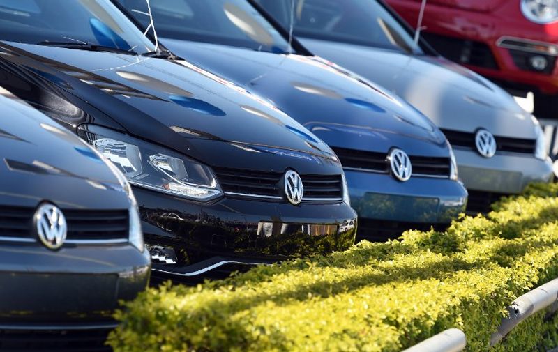 Volkswagen cars are lined up on the forecourt of a dealership in Sydney on October 3, 2015. Embattled auto giant Volkswagen on October 3 suspended the sale of some diesel-powered cars in Australia as the fallout from its emissions-cheating software expanded.  AFP PHOTO / William WEST
