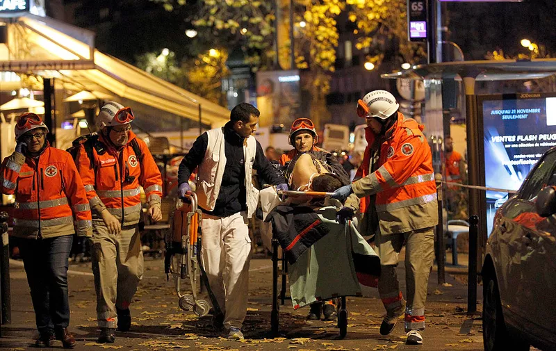 PARIS, FRANCE - NOVEMBER 14:  Medics evacuate an injured person on Boulevard des Filles du Calvaire, close to the Bataclan theater, early on November 14, 2015 in Paris, France. According to reports, over 150 people were killed in a series of bombings and shootings across Paris, including at a soccer game at the Stade de France and a concert at the Bataclan theater.  (Photo by Thierry Chesnot/Getty Images)