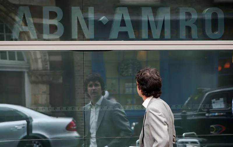 LONDON - APRIL 23:  A man looks to a logo in the window of The UK headquarters of ABN Amro which stands in Bishopsgate on April 23 2007 in London.  It is reported that Dutch bank ABN Amro have accepted Barclays GBP45 billion bid for the company, which would create one of the five biggest banks in the world, called Barclays Group, but employees fear as many as 23,000 jobs could be lost worldwide if the deal between them goes ahead.  (Photo by Matt Cardy/Getty Images)