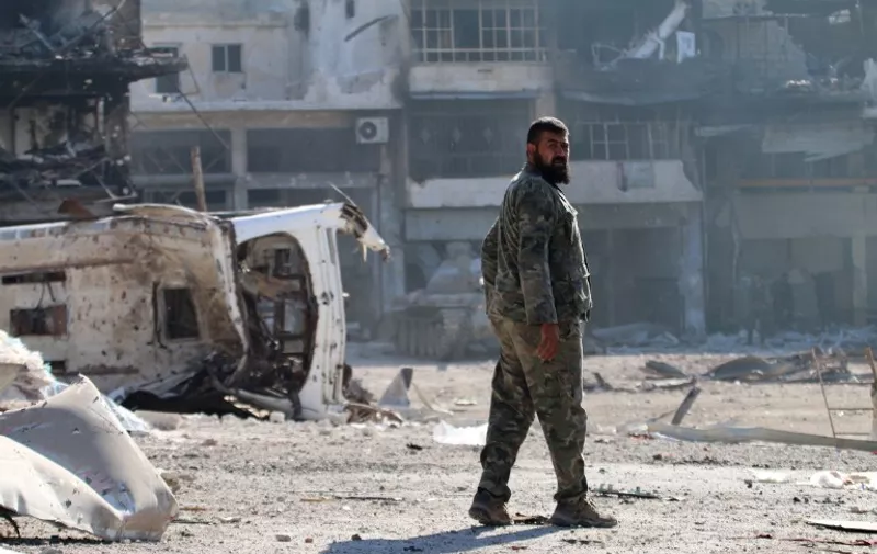 A Syrian pro-regime fighter walks in a bombed-out steet in Ramussa on September 9, 2016, after fellow fighters took control of the strategically important district on the outskirts of the Syrian city of Aleppo the previous day.
The government advance in Ramussa has completely closed access routes into Aleppo's rebel-controlled east, under renewed siege by forces loyal to President Bashar al-Assad.

 / AFP PHOTO / GEORGE OURFALIAN