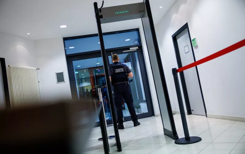 A justice officer secures access to the high security area at the District Court Halle (Justizzentrum) in Halle an der Saale, eastern Germany, on January 25, 2022, before the start of the trial against Leonora M., a young woman charged with membership in a terrorist organization. - The German woman who travelled to Syria as a 15-year-old to join the Islamic State group goes on trial accused of aiding and abetting crimes against humanity. Leonora M., now aged 21, is in the dock on suspicion that she and her IS husband enslaved a Yazidi woman in Syria in 2015. (Photo by JENS SCHLUETER / AFP)