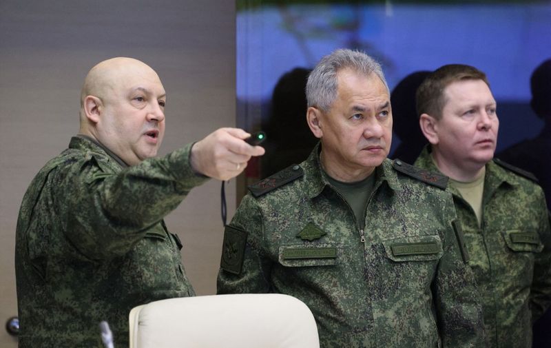General Sergei Surovikin (L), commander of Russia's military operation in Ukraine and Russian Defence Minister Sergei Shoigu (C) are seen during a visit of Russian President to the joint staff of troops involved in Russia's military operation in Ukraine in an undisclosed place on December 17, 2022. (Photo by Gavriil GRIGOROV / Sputnik / AFP) / *Editor's note : this image is distributed by Russian state owned agency Sputnik.*
