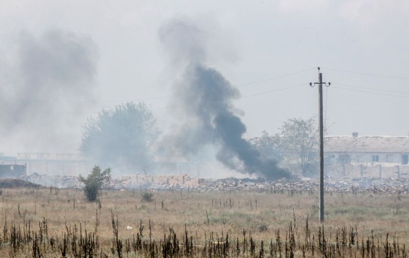 This photo taken on August 16, 2022 shows smoke billowing from a munitions depot in the village of Mayskoye, Crimea. - Russia's defence ministry said on August 16 that a fire that set off explosions at a munitions depot in Moscow-annexed Crimea was caused by an act of "sabotage". (Photo by STRINGER / AFP)