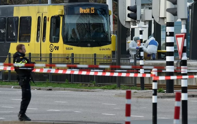 Policemen and rescuers are at work, on March 18, 2019 in Utrecht, near a tram where a gunman opened fire killing at least three persons and wounding several in what officials said was a possible terrorist incident. (Photo by JOHN THYS / AFP)