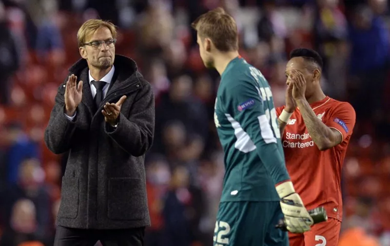 Liverpool's German manager  Jurgen Klopp (L) applauds after a   UEFA Europa League group B football match between Liverpool FC and FC Rubin Kazan at Anfield in Liverpool, north west England, on October 22, 2015.  AFP PHOTO / OLI SCARFF