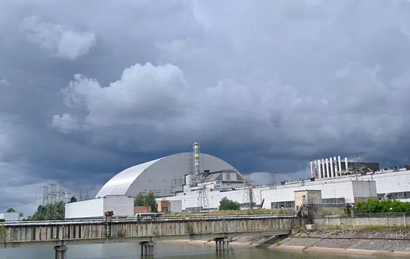 A picture shows a general view of the New Safe Confinement (NSC)  new metal dome designed and built by French consortium Novarka encasing the destroyed reactor at Chernobyl plant on July 10, 2019, in Chernobyl. - Ukraine and its European partners on July 10 formally inaugurated a new metal dome encasing the destroyed reactor at the infamous Chernobyl plant, wrapping up a two-decade effort. Branded as the world's largest moveable metal structure, the so-called New Safe Confinement seals the remains of the fourth reactor at the nuclear plant that was the site of the massive Chernobyl disaster in 1986. (Photo by SERGEI SUPINSKY / AFP)