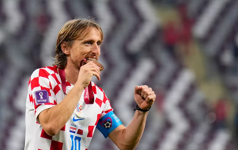 Croatia's Luka Modric celebrates the third place medal at the end of the World Cup third-place playoff soccer match against Morocco at Khalifa International Stadium in Doha, Qatar, Saturday, Dec. 17, 2022. (AP Photo/Hassan Ammar)