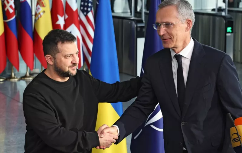 Ukrainian president Volodymyr Zelensky (L) is welcomed by Nato secretary general Jens Stoltenberg at the start of his first visit to NATO's headquarters  since the start of Russia's invasion of Ukraine in February 2022, in Brussels, on October 11, 2023. (Photo by SIMON WOHLFAHRT / AFP)