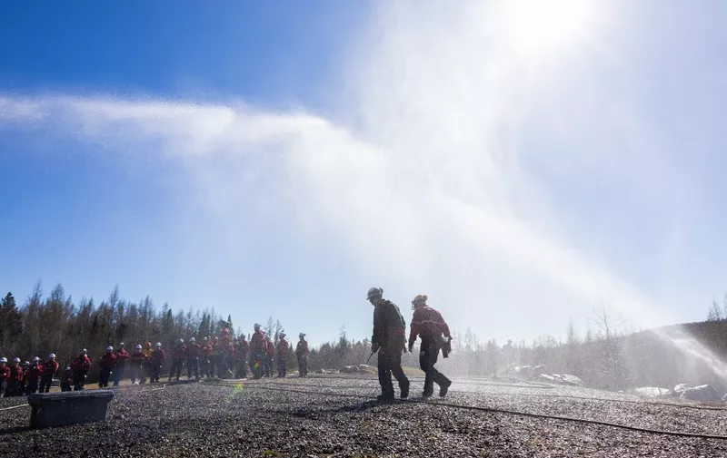 Forest firefighters from the 'Societe de protection des forets contre le feu' (SOPFEU), a non-profit organization in the Canadian province of Quebec, train at the Valcartier military base in Saint-Gabriel-de-Valcartier near Quebec City on May 1, 2024. In response to the major fires of summer 2023, the organization has increased its workforce for the coming season. (Photo by Alexis Aubin / AFP)