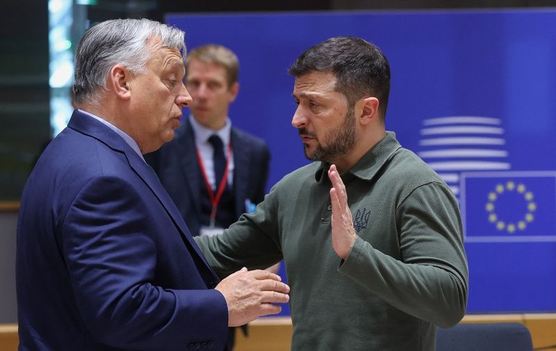 (FILES) Hungarian Prime Minister Viktor Orban (L) talks with Ukraine's President Zelensky during the European Council Summit at the EU headquarters in Brussels on June 27, 2024. After months of treating the European Union with all the evils, Hungarian Prime Minister Viktor Orban takes the rotating presidency on Monday, July 1, 2024, more isolated than ever by his position on the war in Ukraine. (Photo by Olivier HOSLET / POOL / AFP)