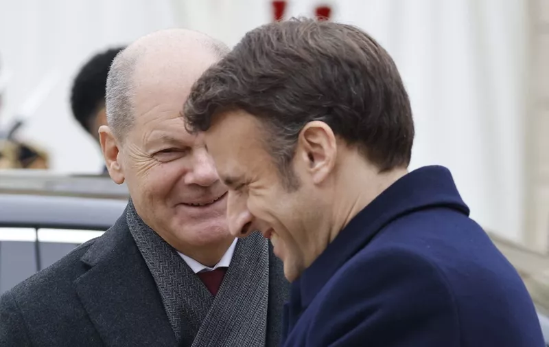 France's President Emmanuel Macron (R) and German Chancellor Olaf Scholz (L) arrive to attend a cabinet meeting as part of the celebration of the 60th anniversary of the signing of the Elysee Treaty, to seal reconciliation between France and West Germany, 18 years after the Second World War at the presidential Elysee Palace in Paris on January 22, 2023. - The date of the reunion is highly symbolic: sixty years to the day after Charles de Gaulle and Konrad Adenauer signed the Elysee Treaty, which "marked the end of decades, if not centuries, of fierce rivalries and bloody wars", write the two leaders in an op-ed published by the German daily Frankfurter Allgemeine Zeitung and the French Journal du dimanche. (Photo by Ludovic MARIN / POOL / AFP)