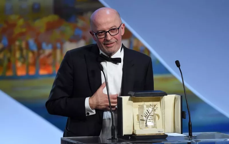French director Jacques Audiard talks on stage after being awarded with the Palme d'Or during the closing ceremony of the 68th Cannes Film Festival in Cannes, southeastern France, on May 24, 2015.       AFP PHOTO / ANNE-CHRISTINE POUJOULAT