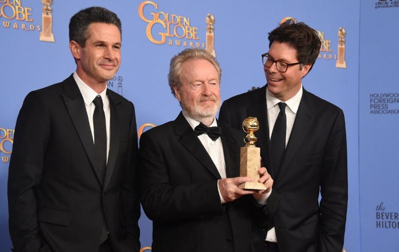 Director Ridley Scott (C) and producers Michael Schaefer and Simon Kinberg pose with the award for Best Motion Picture  Musical or Comedy for The Martian,in the press room at the 73nd annual Golden Globe Awards, January 10, 2016, at the Beverly Hilton Hotel in Beverly Hills, California. AFP PHOTO / FREDERIC J. BROWN / AFP / FREDERIC J BROWN