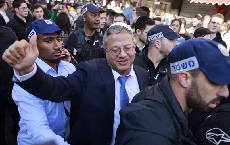 Itamar Ben Gvir, Israel's new Minister of National Security and leader of the far-right Otzma Yehudit (Jewish Power) party, greets supporters during a visit to Jerusalem's Mahane Yehuda market on December 30, 2022. (Photo by Menahem KAHANA / AFP)