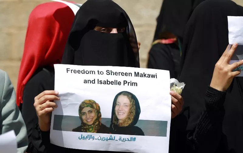(FILES) -- A file photo taken on March 9, 2015 shows Yemeni women taking part in a rally in Sanaa calling for the release of French woman Isabelle Prime and her Yemeni interpreter Sherine Makkaoui who have been kidnapped last month in the capital by unidentified gunmen. The captors of Frenchwoman Isabelle Prime, kidnapped in Yemen on February 24, 2015 posted the first video of her since her abduction. In the 21-second tape posted on YouTube, Prime is shown seated on the ground dressed in black and appeals to the French and Yemeni presidents to take action to secure her release. The 30-year-old, who worked as a consultant on a World Bank-funded project, was seized with her translator Sherine Makkaoui as they were driving to work in the capital Sanaa. There has been no word on the identity of her kidnappers, who were dressed in police uniforms. Makkaoui was later freed. She said she had been released in the southern city of Aden on March 10.   AFP PHOTO / MOHAMMED HUWAIS