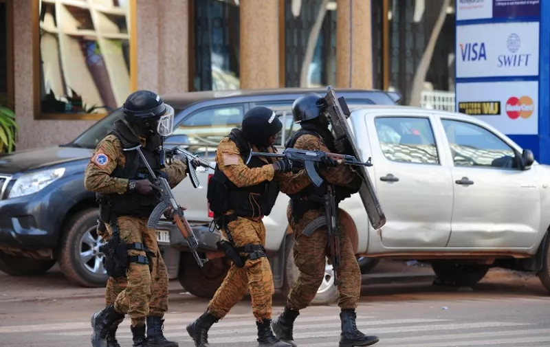 Special police forces are seen during search operations following an attack by Al-Qaeda linked gunmen on January 16, 2016 in Ouagadougou. 
Security forces in Burkina Faso on January 16 completed a counter-offensive against jihadist assailants who stormed a top hotel and a restaurant in the capital hours earlier, a security source said. The source said security forces were continuing search operations in the area around the Splendid hotel and nearby Cappuccino restaurant, which were attacked by the Al-Qaeda-linked gunmen late on January 15, killing at least 23 people. / AFP / AHMED OUOBA