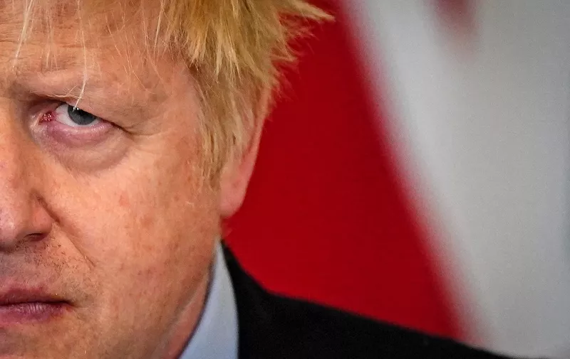 (FILES) In this file photo taken on April 7, 2022 Britain's Prime Minister Boris Johnson reacts during a press conference with Poland's President Andrzej Duda following their meeting at 10 Downing Street, in London. - British Prime Minister Boris Johnson faces a crunch Conservative Party confidence vote later on June 6, 2022 after dozens of his Tory MPs triggered a contest following a string of scandals that have shattered confidence in his leadership. (Photo by Aaron Chown / POOL / AFP)