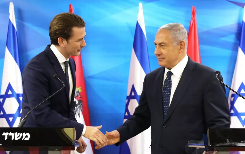 Israeli Prime Minister Benjamin Netanyahu and Austrian Chancellor Sebastian Kurz shake hands during a joint press conference at the prime minister's office in Jerusalem on June 11, 2018. (Photo by AMMAR AWAD / POOL / AFP)