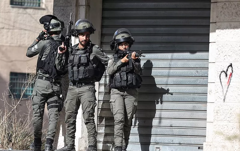 Members of the Israeli border police take positions during a raid at the Balata camp for Palestinian refugees, east of Nablus in the occupied West Bank on November 23, 2023 as violence has escalated in the occupied Palestinian territory amid Israel's war against Hamas in Gaza. (Photo by Zain JAAFAR / AFP)