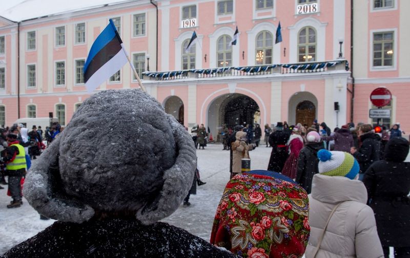 A person with an hat with an Estonian flag is seen as people gather in front of the Estonian Parliament during a festive ceremony to celebrate 100 years since Estonia declared independence for the first time in 1918, in Tallinn on February 24, 2018. (Photo by Raigo Pajula / AFP)