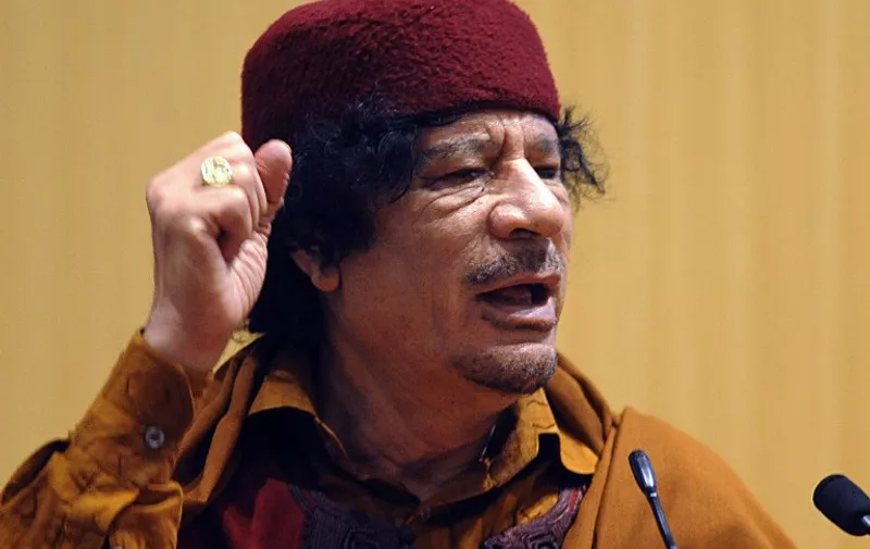 Libyan leader Moamer Gaddafi Kadhafi addresses delegates during the closing  February 04, 2009 ceremony of the 12th African Union summit at the United Nations Headquarters in Ethiopia's capital Addis Ababa. Moamer Kadhafi lavished uncharacteristic praise on a US leader, describing Barack Obama's accession to the White House as a victory against racism and urging the first black American president to lead his country boldly.          AFP PHOTO/SIMON MAINA / AFP / SIMON MAINA