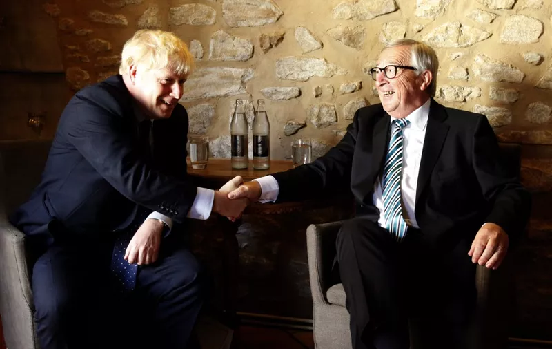 EU Commission president Jean-Claude Juncker (R) shakes hands with British Prime Minister Boris Johnson (L) prior to their meeting, on September 16, 2019 in Luxembourg. - Six weeks before he is due to lead Britain out of the European Union, Prime Minister Boris Johnson meets European commission president, insisting that a Brexit deal is possible. Downing Street has confidently billed the Luxembourg visit as part of efforts to negotiate an orderly divorce from the union before an October 17 EU summit. (Photo by François WALSCHAERTS / AFP)