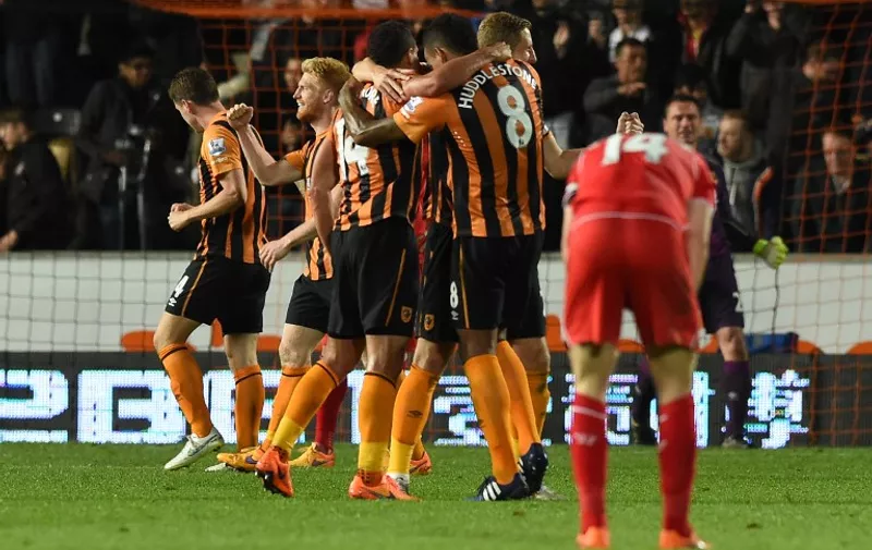 Hull City players celebrate their victory after the final whistle in the English Premier League football match between Hull City and Liverpool at the KC Stadium in Hull, northeast England on April 28, 2015.  AFP PHOTO / PAUL ELLIS

RESTRICTED TO EDITORIAL USE. No use with unauthorized audio, video, data, fixture lists, club/league logos or live services. Online in-match use limited to 45 images, no video emulation. No use in betting, games or single club/league/player publications.