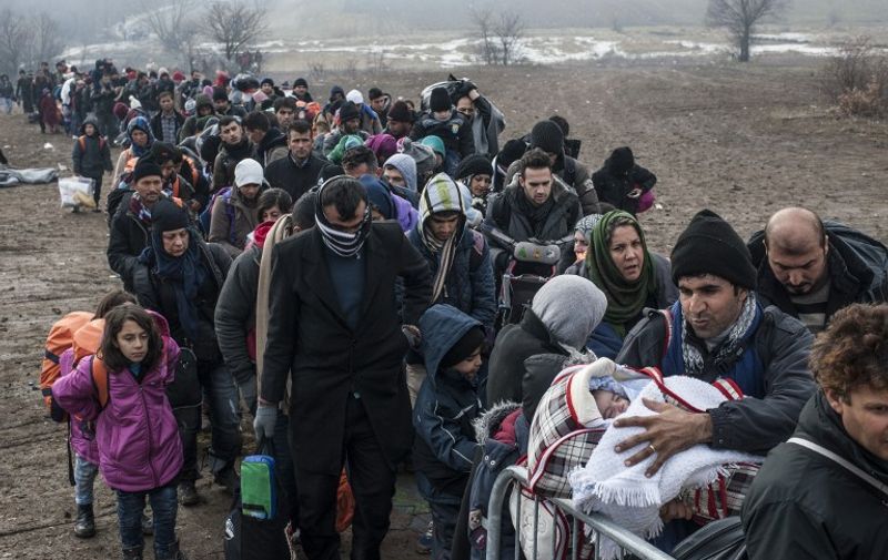Migrants and refugees wait for security check after crossing the Macedonian border into Serbia, near the village of Miratovac, on January 29, 2016. 

More than one million migrants and refugees crossed the Mediterranean Sea to Europe in 2015, nearly half of them Syrians, according to the UN refugee agency, UNHCR. The International Organisation for Migration said las week that 31,000 had arrived in Greece already this year. / AFP / ARMEND NIMANI