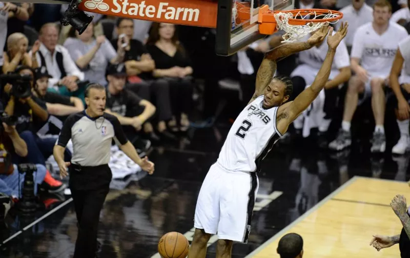 Kawhi Leonard of the San Antonio Spurs dunks the ball against the Miami Heat during Game 5 of the NBA Finals on June15, 2014 at the AT&amp;T Center in San Antonio,Texas.  AFP PHOTO / Robyn Beck / AFP / ROBYN BECK