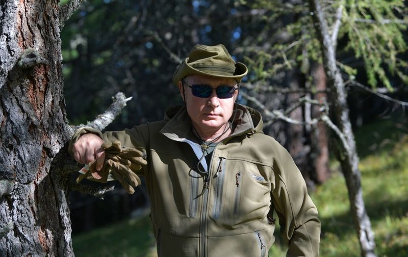 Russian President Vladimir Putin poses during his leisure time in the Siberian Taiga area on October 6, 2019. (Photo by Alexey DRUZHININ / Sputnik / AFP)