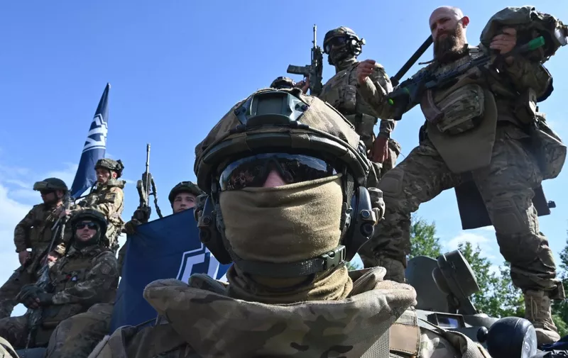 Fighters of the Russian Volunteer Corps attend a presentation for the media in northern Ukraine, not far from the Russian border, on May 24, 2023, amid Russian military invasion on Ukraine. Russian nationals fighting on Ukraine's side on May 24 hailed as a "success" a brazen mission to send groups of volunteers across the border into southern Russia and back. Russia on May 23 said it deployed jets and artillery to fight off armed attackers who crossed into the southern region of Belgorod from Ukraine, exposing weaknesses on Moscow's frontier. (Photo by SERGEY BOBOK / AFP)