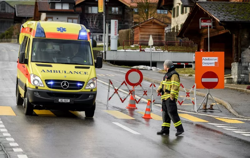 A ambulance crosses a check point to access the closed road leading to the Adelboden FIS Alpine Ski World Cup races, after a landslide following winter storm Eleanor cut a part the road between Frutigen and Adelboden, Bernese Alps, on January 5, 2018 in Frutigen. (Photo by Fabrice COFFRINI / AFP)