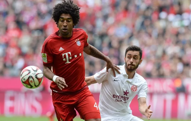 Bayern Munich's Brazilian defender Dante (L) and Mainz's midfielder Yunus Malli vie for the ball during German first division Bundesliga football match FC Bayern Munich vs 1 FSV Mainz 05 at the Allianz Arena in Munich, southern Germany on May 23, 2015.  AFP PHOTO / CHRISTOF STACHE

RESTRICTIONS - DFL RULES TO LIMIT THE ONLINE USAGE DURING MATCH TIME TO 15 PICTURES PER MATCH. IMAGE SEQUENCES TO SIMULATE VIDEO IS NOT ALLOWED AT ANY TIME. FOR FURTHER QUERIES PLEASE CONTACT DFL DIRECTLY AT + 49 69 650050.