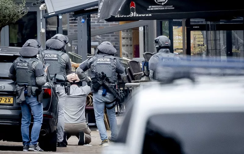 A man is arrested by members of the DSI special police forces after several people were taken hostages in a cafe in Ede, on March 30, 2024. Everyone being held hostage in a town in central Netherlands is now free and a suspect is in custody, Dutch police said on March 30, 2024, after an ordeal that lasted several hours. (Photo by Remko de Waal / ANP / AFP) / Netherlands OUT
