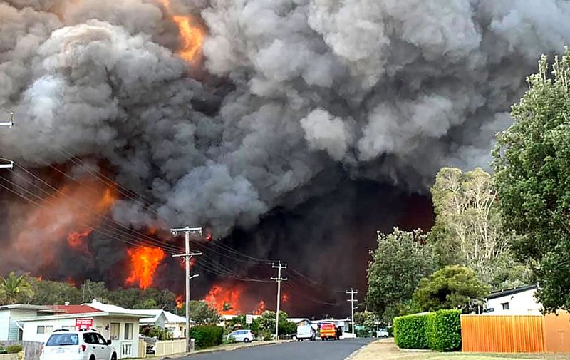 This handout picture taken and received from Kelly-ann Oosterbeek on November 8, 2019 shows flames from an out of control bushfire seen from a nearby residential area in Harrington, some 335 kilometers northeast of Sydney. - Australian firefighters warned they were in "uncharted territory" as they struggled to contain dozens of out-of-control bushfires across the east of the country on November 8. (Photo by Kelly-ann Oosterbeek / Kelly-ann Oosterbeek / AFP) / RESTRICTED TO EDITORIAL USE - MANDATORY CREDIT "AFP PHOTO / KELLY-ANN OOSTERBEEK" - NO MARKETING NO ADVERTISING CAMPAIGNS - DISTRIBUTED AS A SERVICE TO CLIENTS == NO ARCHIVE