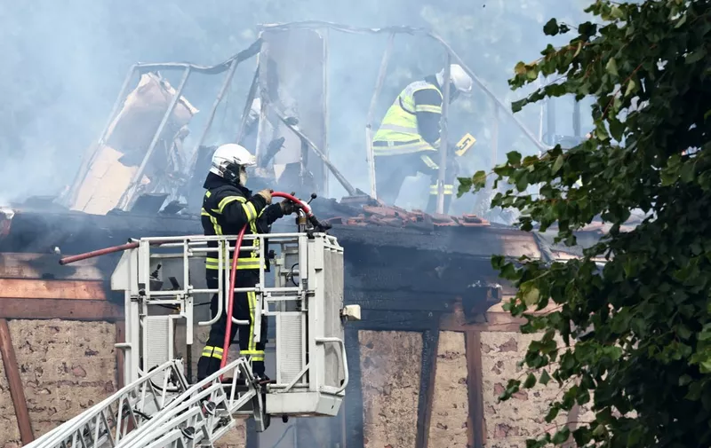 Firefighters work to extinguish a fire which erupted at a home for disabled people in Wintzenheim near Colmar, eastern France, on August 9, 2023. Seventeen people were evacuated and at least 11 are still reported missing. (Photo by Sebastien BOZON / AFP)