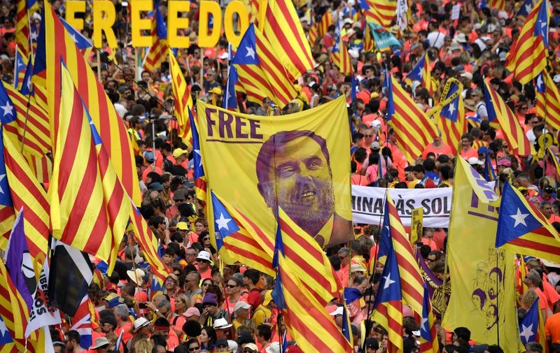 Demonstrators hold a banner demanding freedom for Catalan jailed leader Oriol Junqueras as they gather to take part in a pro-independence demonstration in Barcelona, on September 11, 2018, marking the National Day of Catalonia, the "Diada". - Catalan separatists will seek to put on a show of strength and unity at celebrations of the region's national day today, nearly a year after a failed attempt to break away from Spain. Catalonia's national day, the 'Diada' commemorates the fall of Barcelona in the War of the Spanish Succession in 1714 and the region's subsequent loss of institutions and freedoms. (Photo by LLUIS GENE / AFP)
