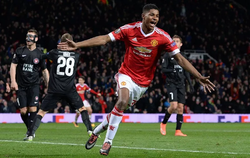 Manchester United's English striker Marcus Rashford celebrates scoring his team's third goal during the UEFA Europa League round of 32, second leg football match between Manchester United and and FC Midtjylland at Old Trafford in Manchester, north west England, on February 25, 2016. / AFP / OLI SCARFF