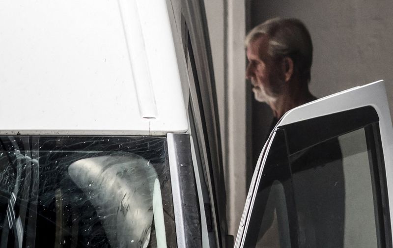 Retired British miner David Hunter, convicted of killing his terminally ill wife to relieve her suffering, enters a police van as he leaves the court, after a mitigation hearing, in Paphos on July 27, 2023. (Photo by Iakovos Hatzistavrou / AFP)
